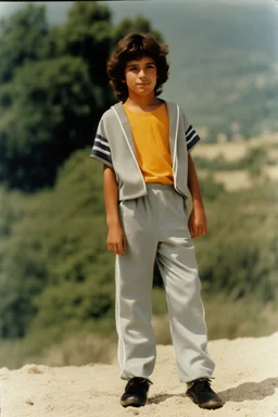 eleven year old mediterranean boy dressed track pants, early 80's color photo