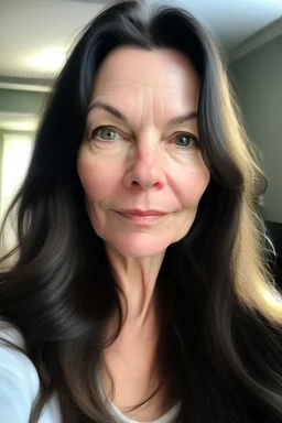 A selfie of a brunette woman with a round face, long hair taken at spa salon. showing incredibly beautiful extremely attractive 57-year-old European woman. (She has white skin, tousled black hair, pretty face without makeup, big round brown eyes, cute profiled nose, detailed full lips.)