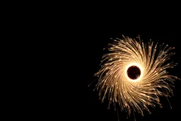 dark background. rotating circle of energy(bottom and right) giving off sparks