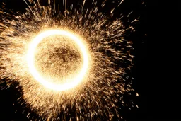 dark background. spinning circle of sparks (bottom and right)