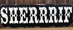 large and wide hand painted old western sign that reads: "SHERRIF" white on black with inset boarder stripe in white aged