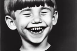 Photo of a bUck-toothed boy with a Huge grin and Bowlcut, closed eyes