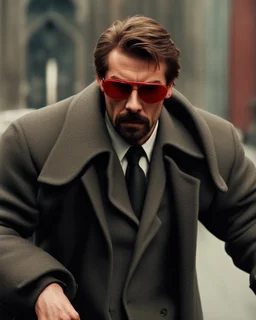 a young man with big muscles who looks like hans gruber wearing a heavy coat and red sunglasses staring with an irritated look on his face