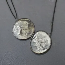 pendant in a form of two conjoined silver coins, watercolor, large strokes, illustration, fantasy