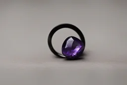 небольшое чёрное кольцо с лиловым камнем выпало на пол.