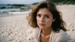 woman sitting on beach, candid RAW film, 16mm, Portra 400 color film, remarkable color, ultra-realistic, textured skin, remarkable detailed pupils, realistic faint skin noise, visible skin detail, skin fluffiness, dry skin, shot on movie camera