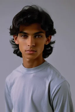 Appearance: Ari has a mixed-race skin tone with a light brown complexion. He has dark hair in a page boy haircut that sticks out from behind his ears, and his hair length could be somewhere in-between long and short. His face is thin with high cheekbones and blue eyes that are often full of emotion and a gentle smile. He stands at around 5 feet 7 inches tall, with a lean build that suggests he doesn't engage in a lot of physical activity. He is of average attractiveness with a boyish face.