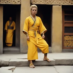 [very impressive high res masterpiece in Kodak Eastman 5247, bokeh scene by Stanley Kubrick] Elizabeth Montgomery, the Shaolin gangsta monk covered by tattoos, waiting outside in a yellow kimono on a stone doorstep. Her presence is striking, the tattoos on her knuckles adding to her intimidating aura. With a fierce glare, she menaces the camera with her two fists, each knuckle etched with intricate designs symbolizing her journey and battles fought.