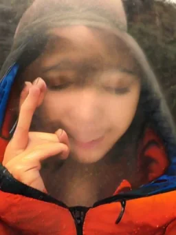 reflection of girls face in the mist of a waterfall