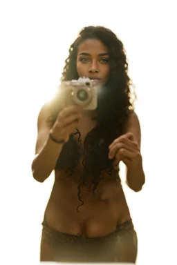 A realistic selfie-style self-portrait of a confident influencer aged 18-37 in an urban setting, dressed in trendy sportswear or beachwear to showcase her slender figure. Her creative curly black hair shines under softbox lighting accentuating her flawless skin. The vintage camera shot with a macro lens introduces a charming bokeh effect. Every detail, from her complexion to body contour, is outlined for a high-quality image –ar 4:5 –testp –upbeta –octane.