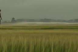 man touching grass by Roger Deakins