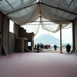 A Hasselblad H6D-400c photo of an odd room with structures. A transparent tarpaulin covers a ruined building. There is a group of people in the background and a high hill in the distance. The surface below is in a pastel color. Fog is present.