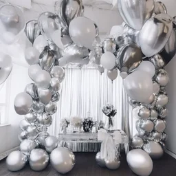 A picture of a room filled with silver party decoration. Include balloons, garlands, foil balloons