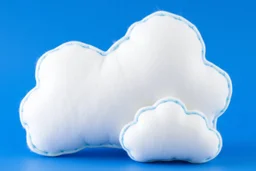 white plushie stuffed toy clouds with blue yarn stitching around edge, blue background