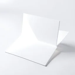 A photo of a white folded card, 5.5 by 4.25 inches. The card is laying vertically on a beautiful white surface.