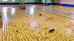 lady dirties wood floor in public fitness gym