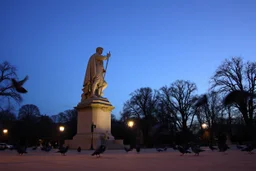 Park statue coming alive at twilight, stone becoming flesh gradually, pigeons unfazed, living monument