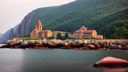 stone and brick monastery on a rocky shore