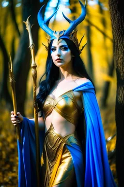 A picture of a beautiful blue faced Korean goddess with skin painted blue, blue body, blue torso, wild black hair, stag antlers, elven ears, golden skirt, holding a staff in a sunny forrest