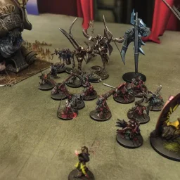 Priest smiting demonic Warlord,armies battling in the background, grimdark.