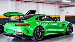 Mercedes-Benz AMG GT63s, green, with four side doors parked in a luxury garage, with the car facing right