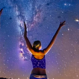 woman in tank top pointing to the night sky