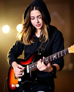 attractive woman(wearing a dark hoodie of light material) playing an electric guitar at vertical angle