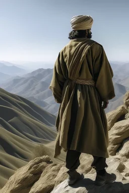 A general in Arab clothing standing from behind on a mountain, his face not visible