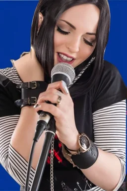 attractive female country music singer leaning forward while holding microphone in one hand, other hand brought up to side of neck, change clothing to plaid in natural tones, leather bracelets on wrists, long hair, mouth open singing, rings on fingers, eyes closed