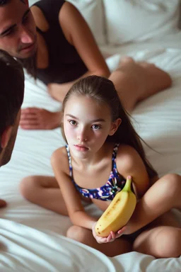 young teenage girl in a swimsuit on a bed. eating a banana. with dad