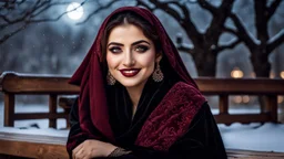 Hyper Realistic Photographic View of a Young Beautiful Pashto Woman with beautiful eyes & lips in black-velvet-dress-with-maroon-embroidery-&-black-velvet-shawl, Smiling having Dimples on her cheeks & sitting on a fancy-wooden bench in a-park with an old-thick-tree & moonlight-rays at dark-heavy-snowfall-night showing dramatic & cinematic ambiance.