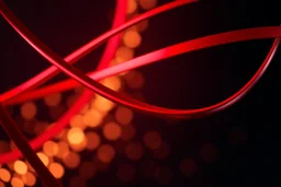 Macro-scale abstract photography of smooth, glossy red metallic ribbons curving diagonally. Vibrant highlights and deep shadows create a strong sense of form and depth. The dark background is filled with soft, warm golden bokeh lights. Professional studio lighting, 8k resolution, sleek and modern aesthetic.