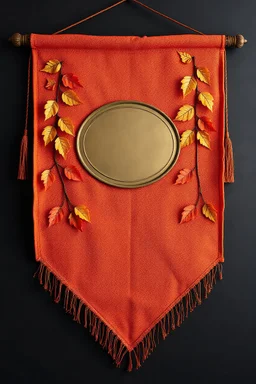 an autumn colored textured cloth banner hanging with embroidered ornamental leaves, blank oval brass engraving plate in middle, banner is downward pointed bottom, on dark background