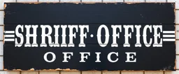 fill composition with large and wide historical hand painted old western sign that reads: "SHRIFF OFFICE" white on black with inset white stripe boarder aged paint on wood sanserif