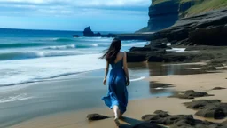 A young woman with long dark hair wearing a blue dress walking on a beach with rocky cliffs in the background and a calm, reflective ocean