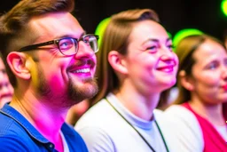 His eyes are focused on the audience, demonstrating direct communication and the potential impact of his presentation on them. The audience is made up of a variety of people, with some appearing smiling and looking eager to hear what the speaker is offering. Others may be writing notes or showing their preoccupation with the presentation.