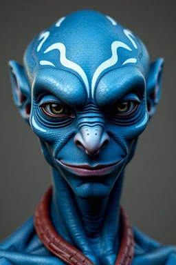 Attractive Male alien. He has blue, scaly, smooth skin, with white markings on his forehead and around his eyes. His ears are pointed and he has wide mouth with no lips. He is smirking.