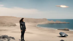 A woman in a catsuit standing on a beach of a rocky landscape with a crashed spaceship in the distance