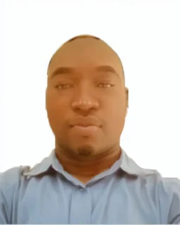 passport picture of black man with a brown shirt and hidden facial mark