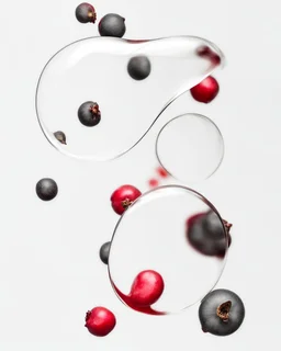 pomegranate seeds are scattered on a white background