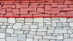 A wall designed with red and gray mesh broken stone