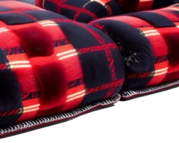 Red plaid men's slipper, fur rug