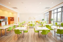 A 3D hyperrealistic 3D image in 4K resolution of a modern party and birthday room (about 100 sq m) with arranged tables, green chairs, lots of light and a kitchenette.