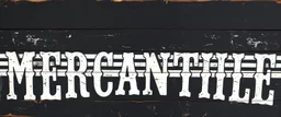 fill composition with large and wide historical hand painted old western sign that reads: "MERCANTILE" white on black with inset white stripe boarder aged paint on wood sanserif