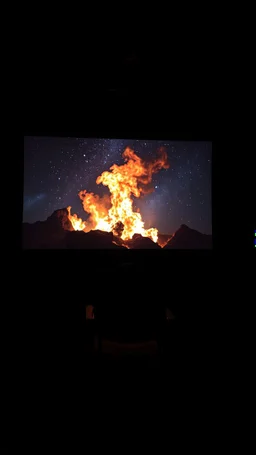 An old movie projector in side an empty dark room with an empty chair facing the screen, in the screen is picture of fire in the sky in the starry night on burned slide picture the , show the beam of the projector to the screen
