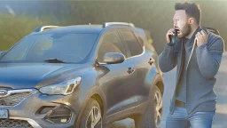 guy arguing on cellphone with his kia sportage