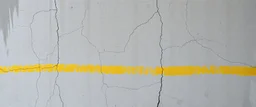 background of with a wall(wet textured concrete, gray, old, cracked, stained) yellow hashmark stripe across wall