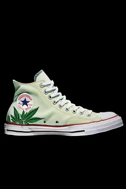 A red converse sneaker with weed leaves printed on the material, green, yellow and red colors