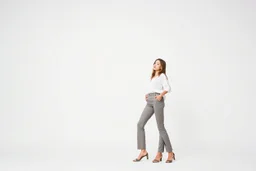 empty simple background and cloudes a beautiful young lady wearing pants and blouse standing gracefully