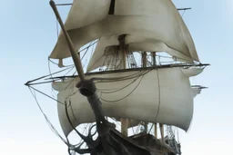 front view of a wooden ship with a spider figurehead